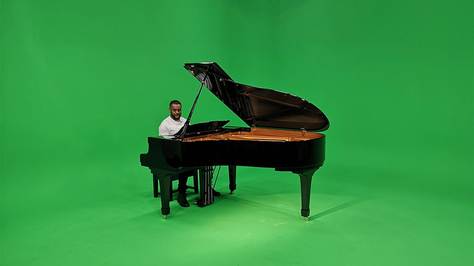 manchester studio hire with large greens screen studio A man plays a piano on a green screen in our manchester studio hire